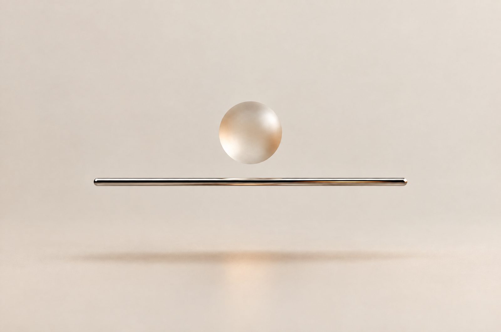 A frosted glass sphere floating above a thin steel rod
